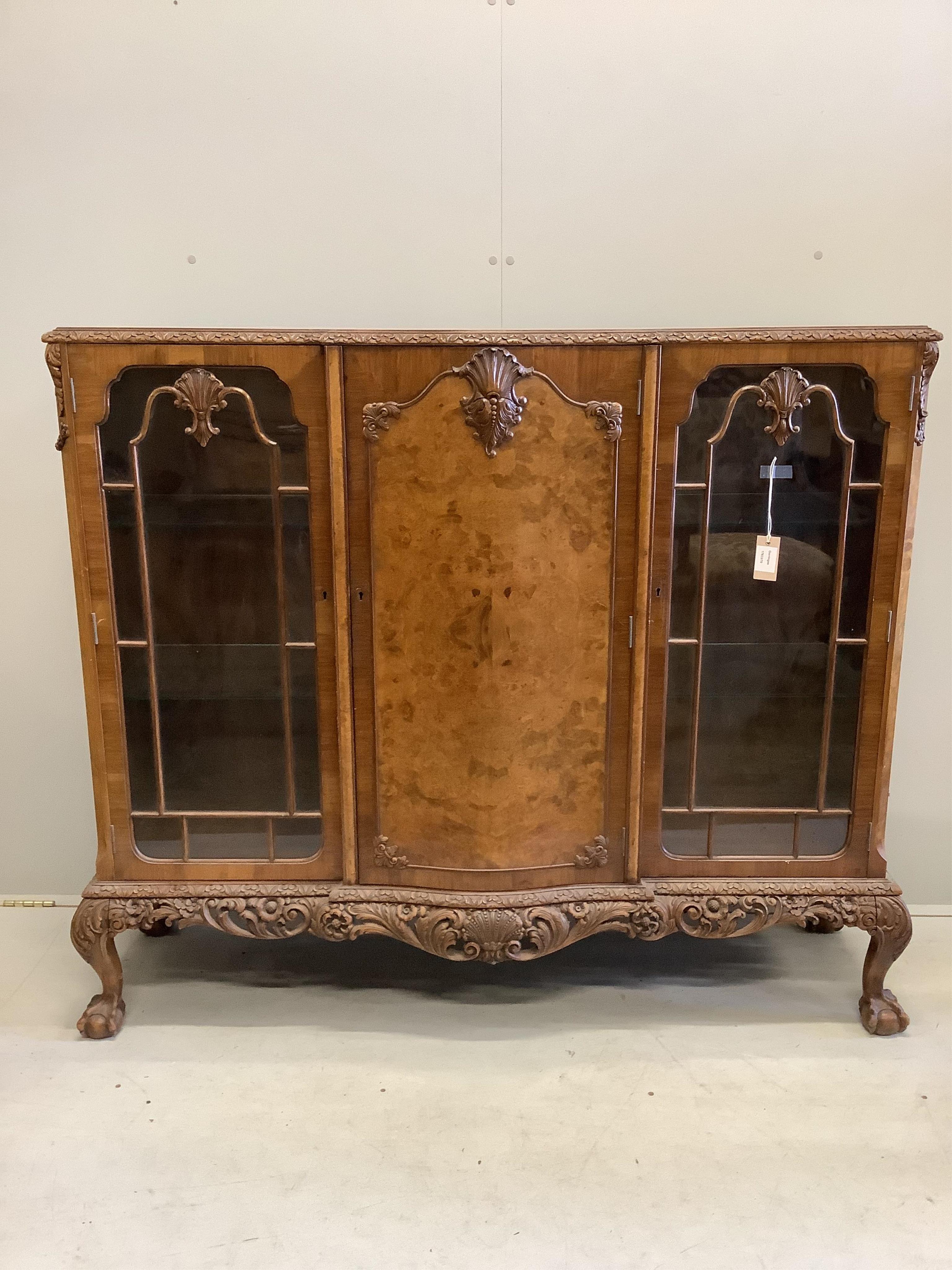 A Queen Anne revival walnut bookcase cupboard, width 136cm, depth 40cm, height 121cm